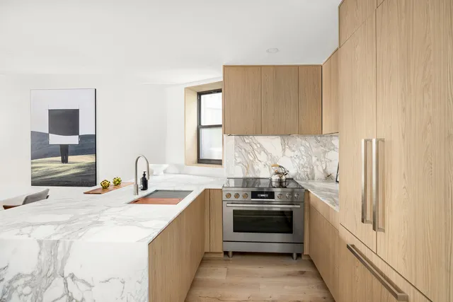 a kitchen with stainless steel appliances granite countertop a sink and a refrigerator