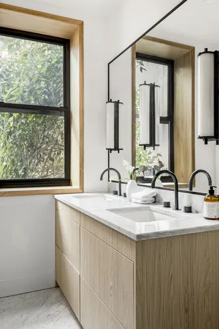 a bathroom with a double vanity sink toilet and shower