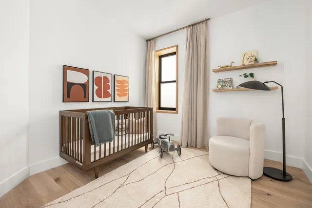 a bedroom with bed and night stand