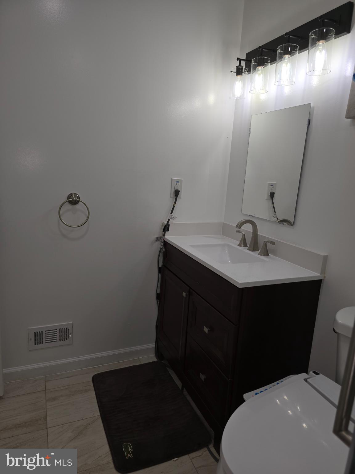 20000 Wyman Way Germantown, MD 20874 - Photo 11 of 56 a bathroom with a sink vanity mirror and toilet