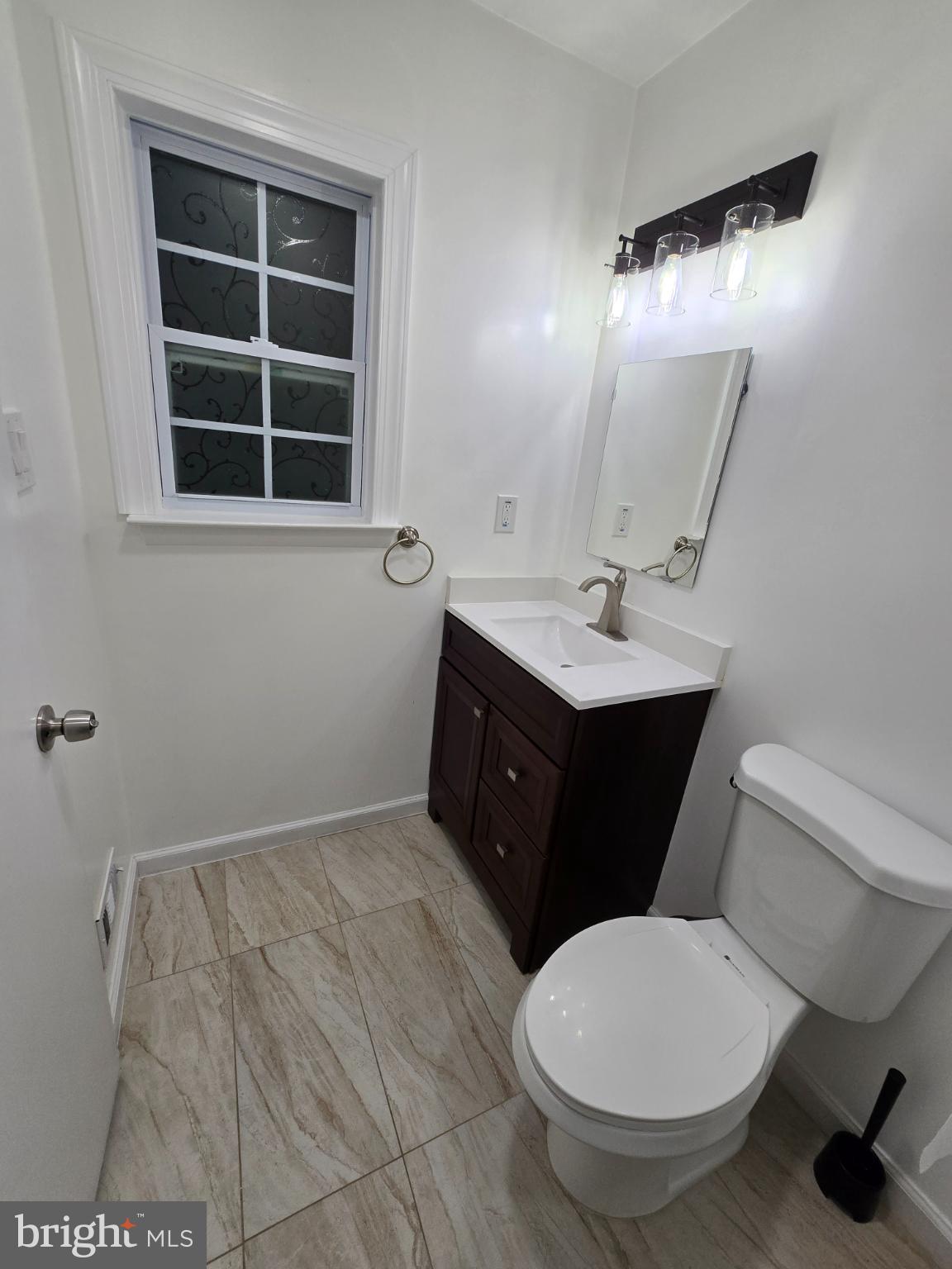 20000 Wyman Way Germantown, MD 20874 - Photo 23 of 56 a bathroom with a toilet sink and mirror