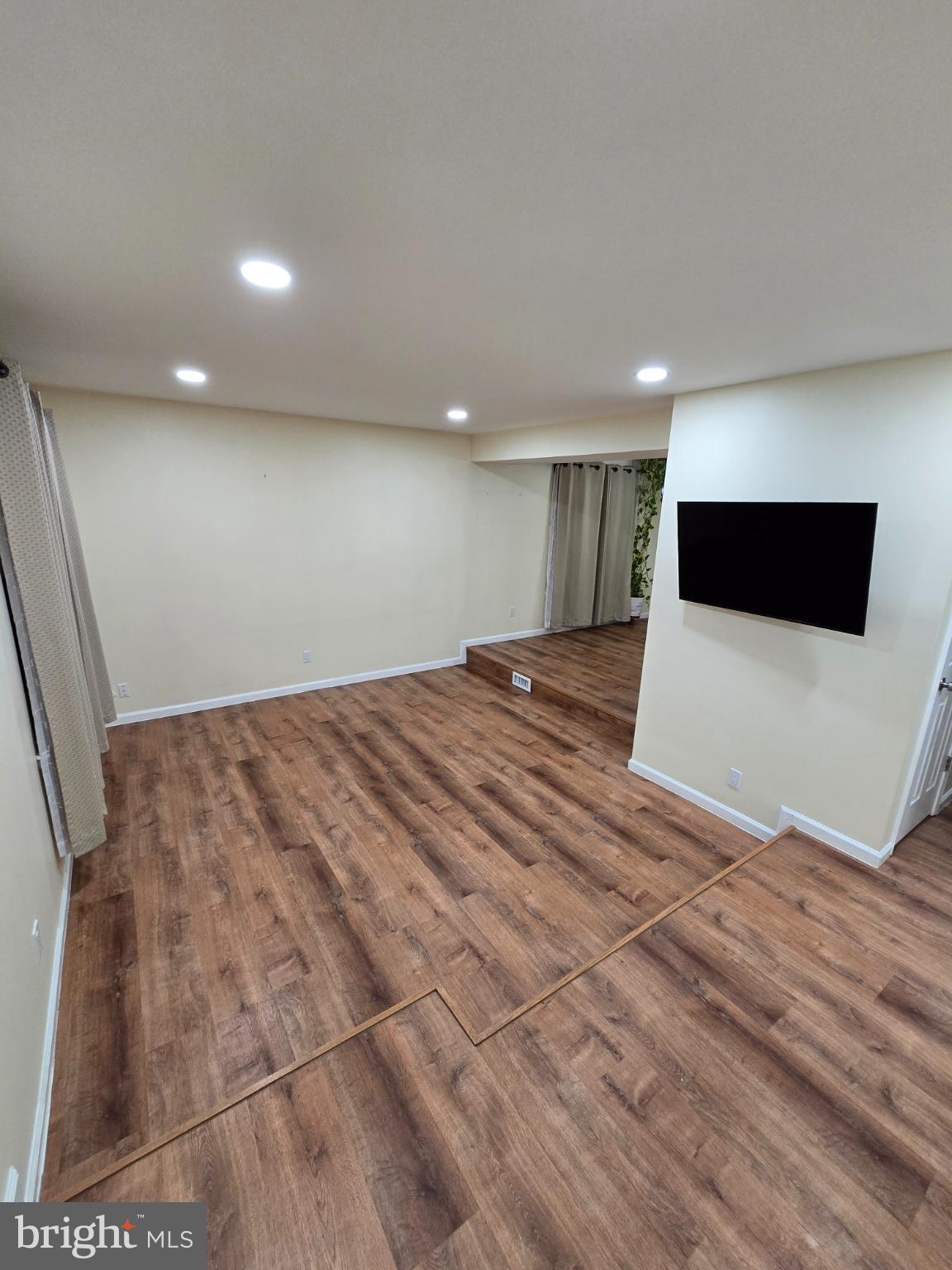 20000 Wyman Way Germantown, MD 20874 - Photo 35 of 56 a view of a livingroom with an empty space and wooden floor