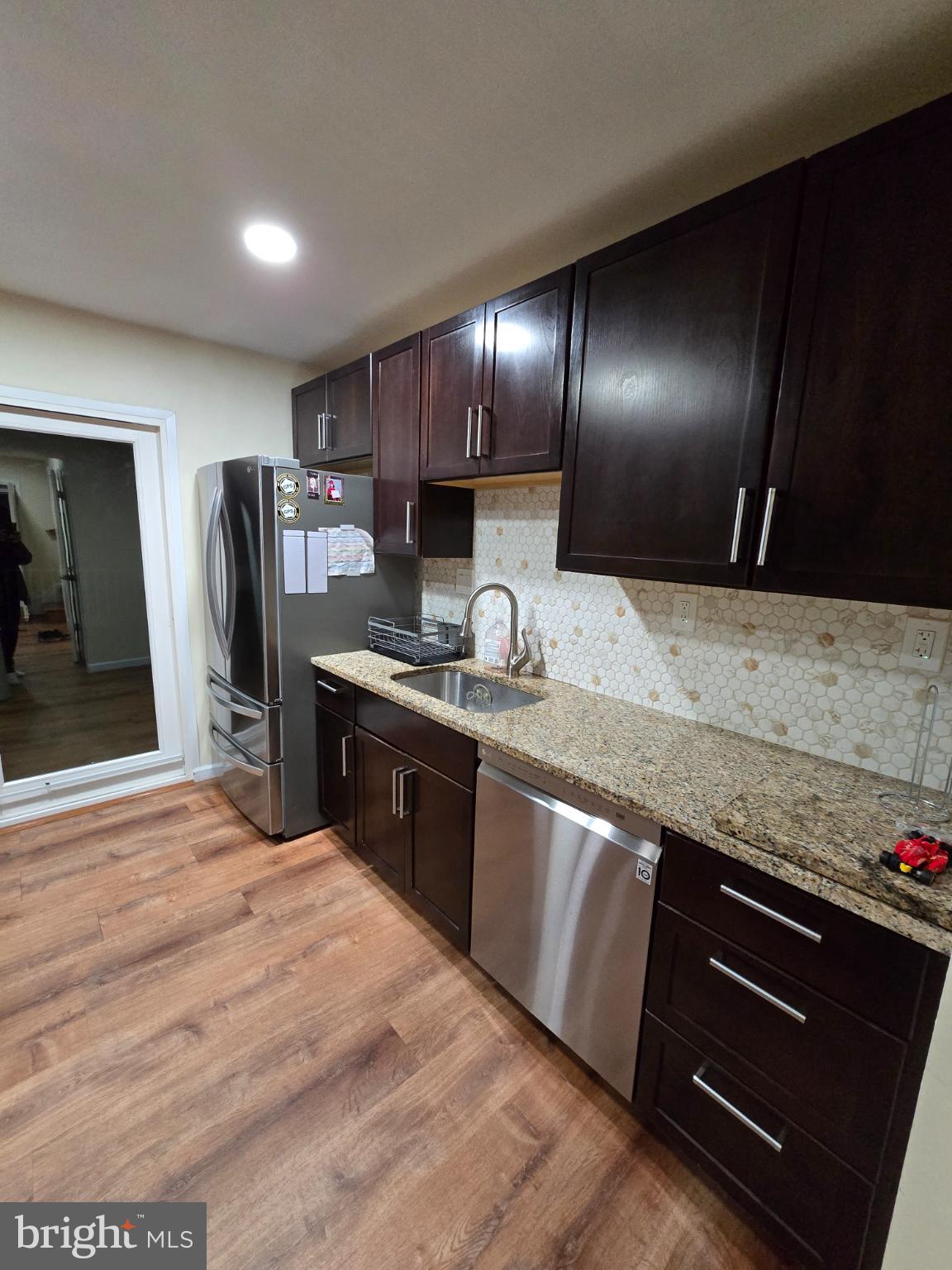 20000 Wyman Way Germantown, MD 20874 - Photo 5 of 56 a kitchen with granite countertop stainless steel appliances and wooden cabinets