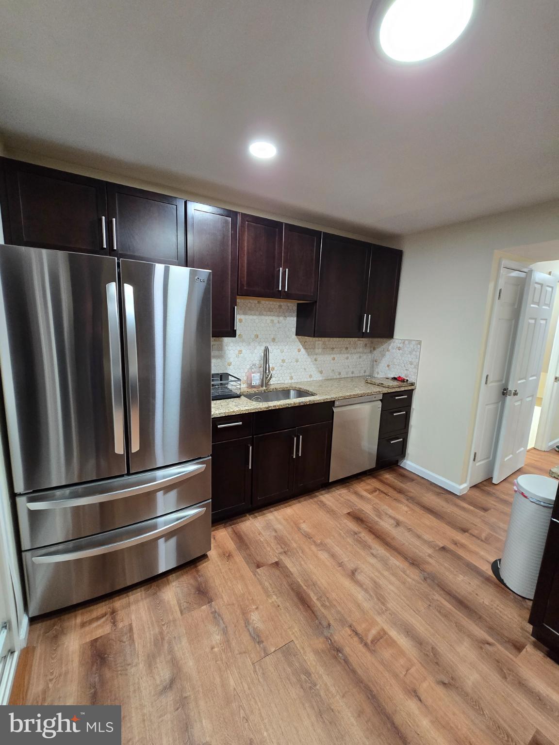 20000 Wyman Way Germantown, MD 20874 - Photo 8 of 56 a kitchen with stainless steel appliances kitchen island granite countertop a refrigerator and a sink