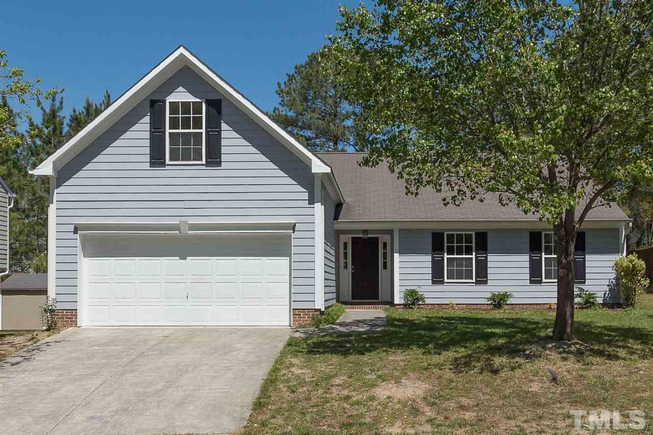 3809 Toyon Drive Raleigh, NC 27616 - Photo 2 of 20 a front view of a house with a yard and garage