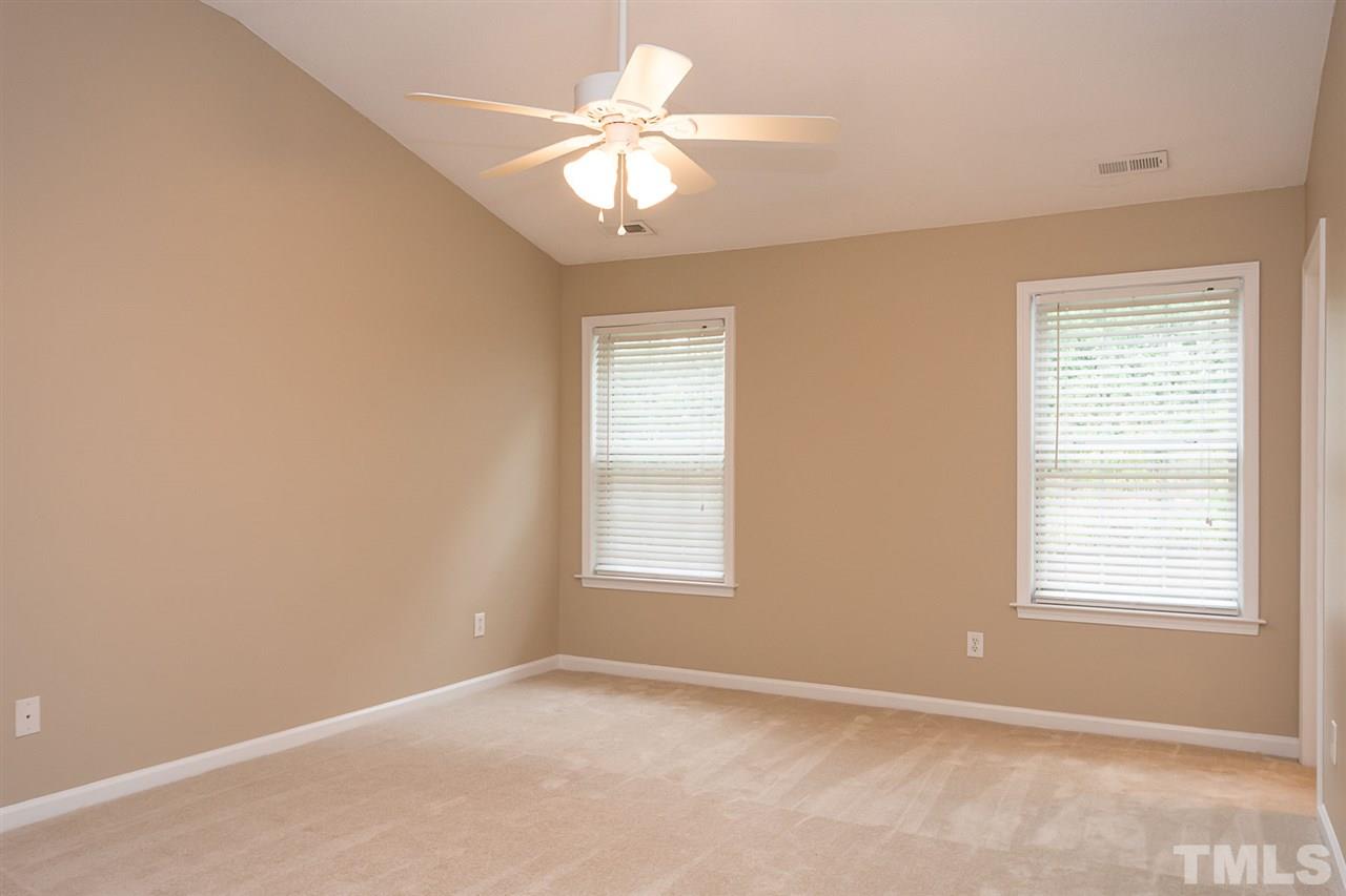 3809 Toyon Drive Raleigh, NC 27616 - Photo 13 of 20 an empty room with windows and chandelier fan