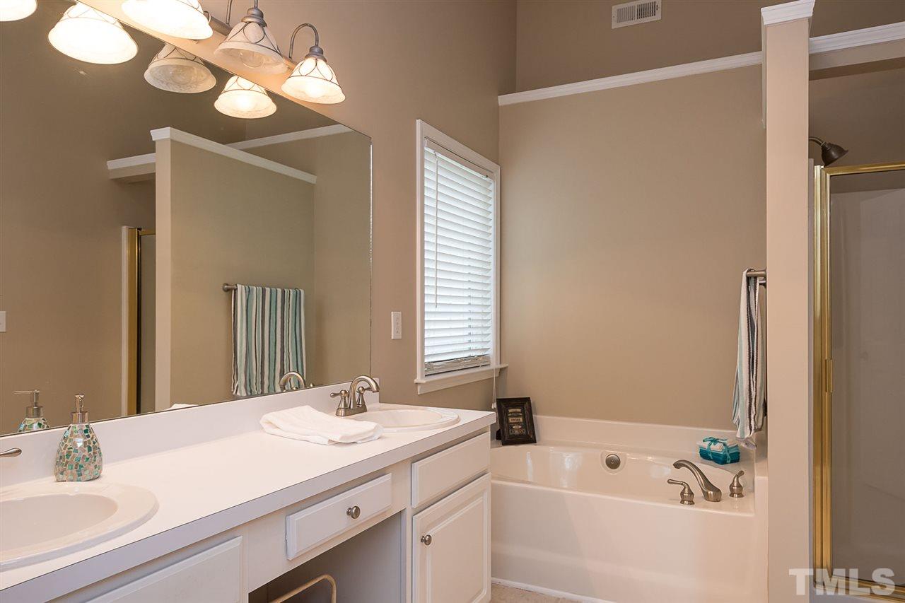 3809 Toyon Drive Raleigh, NC 27616 - Photo 14 of 20 a bathroom with a tub sink and mirror