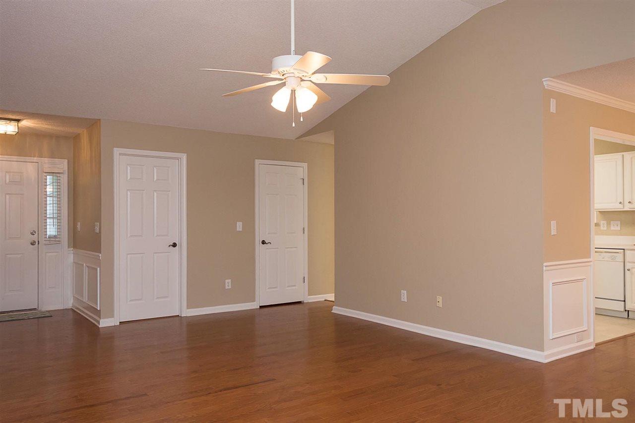 3809 Toyon Drive Raleigh, NC 27616 - Photo 3 of 20 a view of an empty room with wooden floor and a window
