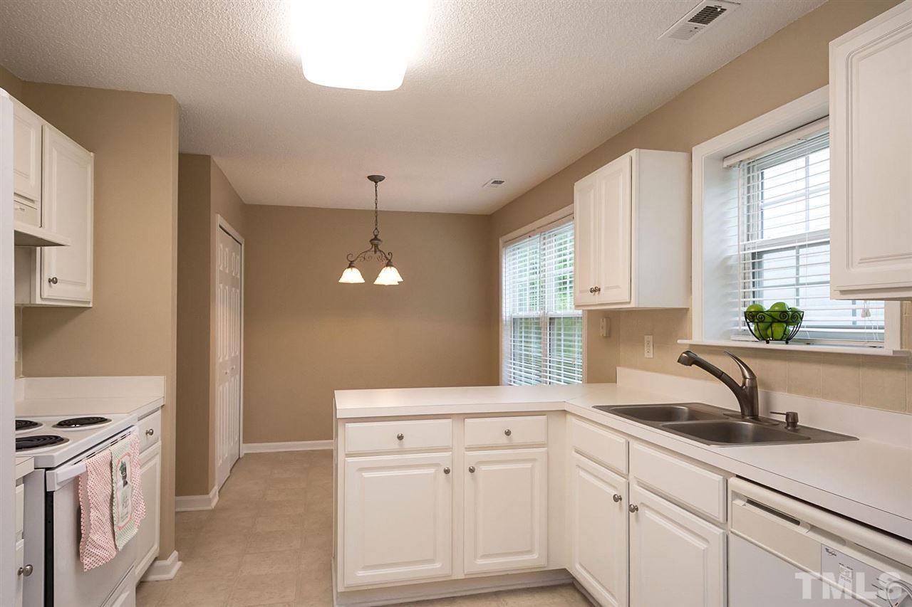 3809 Toyon Drive Raleigh, NC 27616 - Photo 6 of 20 a kitchen with white cabinets and sink