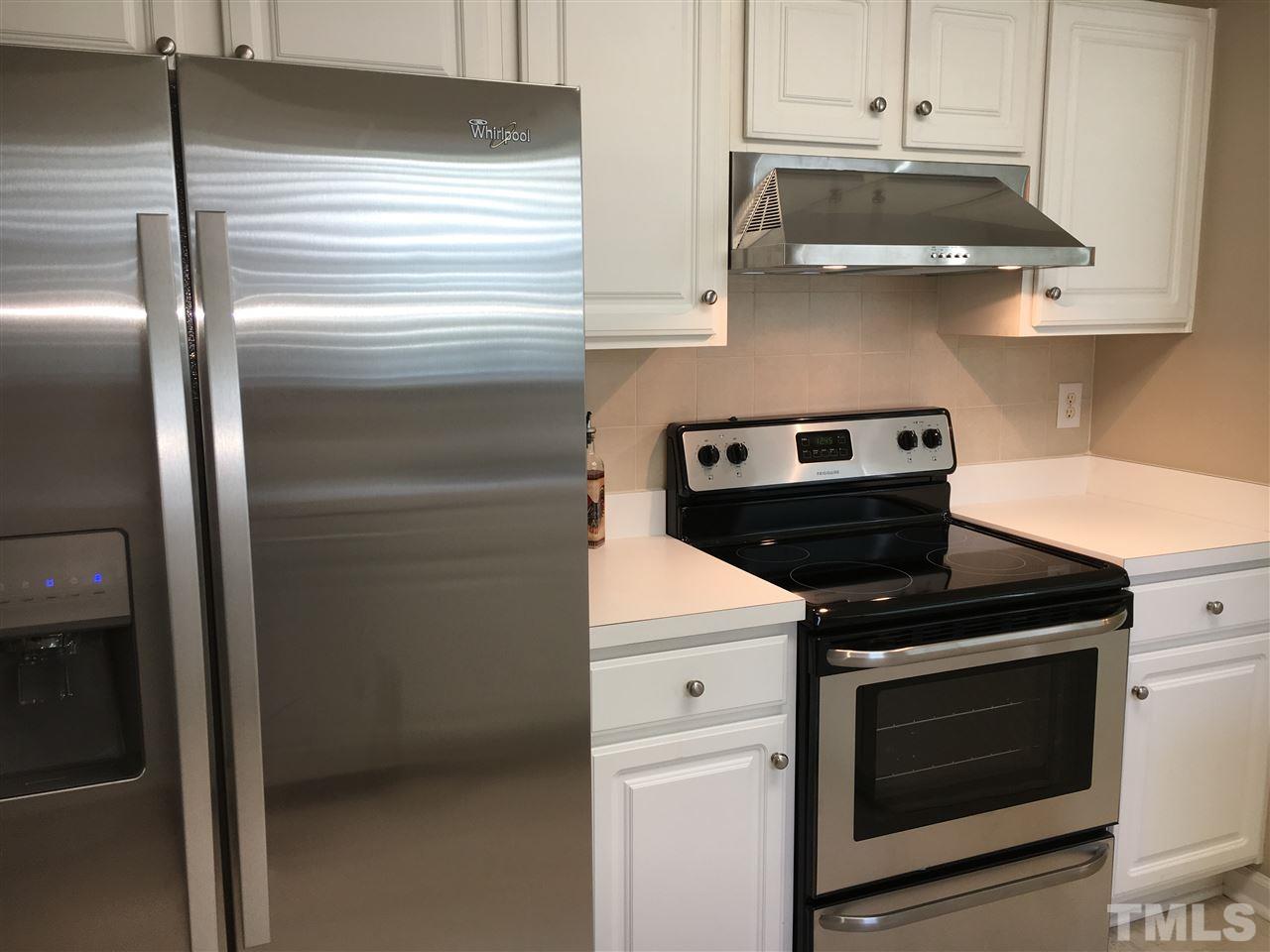 3809 Toyon Drive Raleigh, NC 27616 - Photo 7 of 20 a kitchen with stainless steel appliances granite countertop a stove and a refrigerator