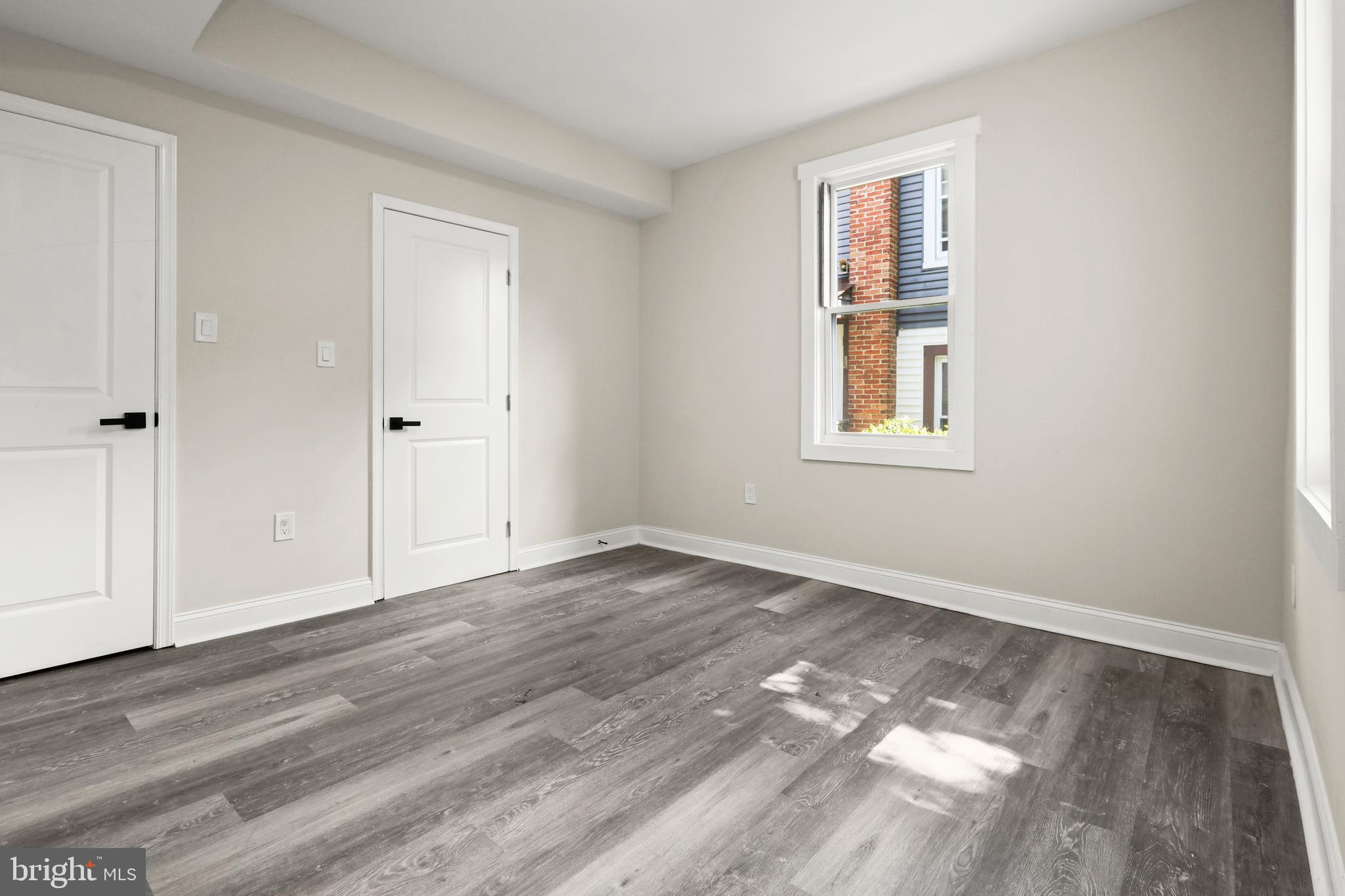 505 McCabe Avenue Baltimore, MD 21212 - Photo 14 of 46 a view of an empty room with wooden floor and a window