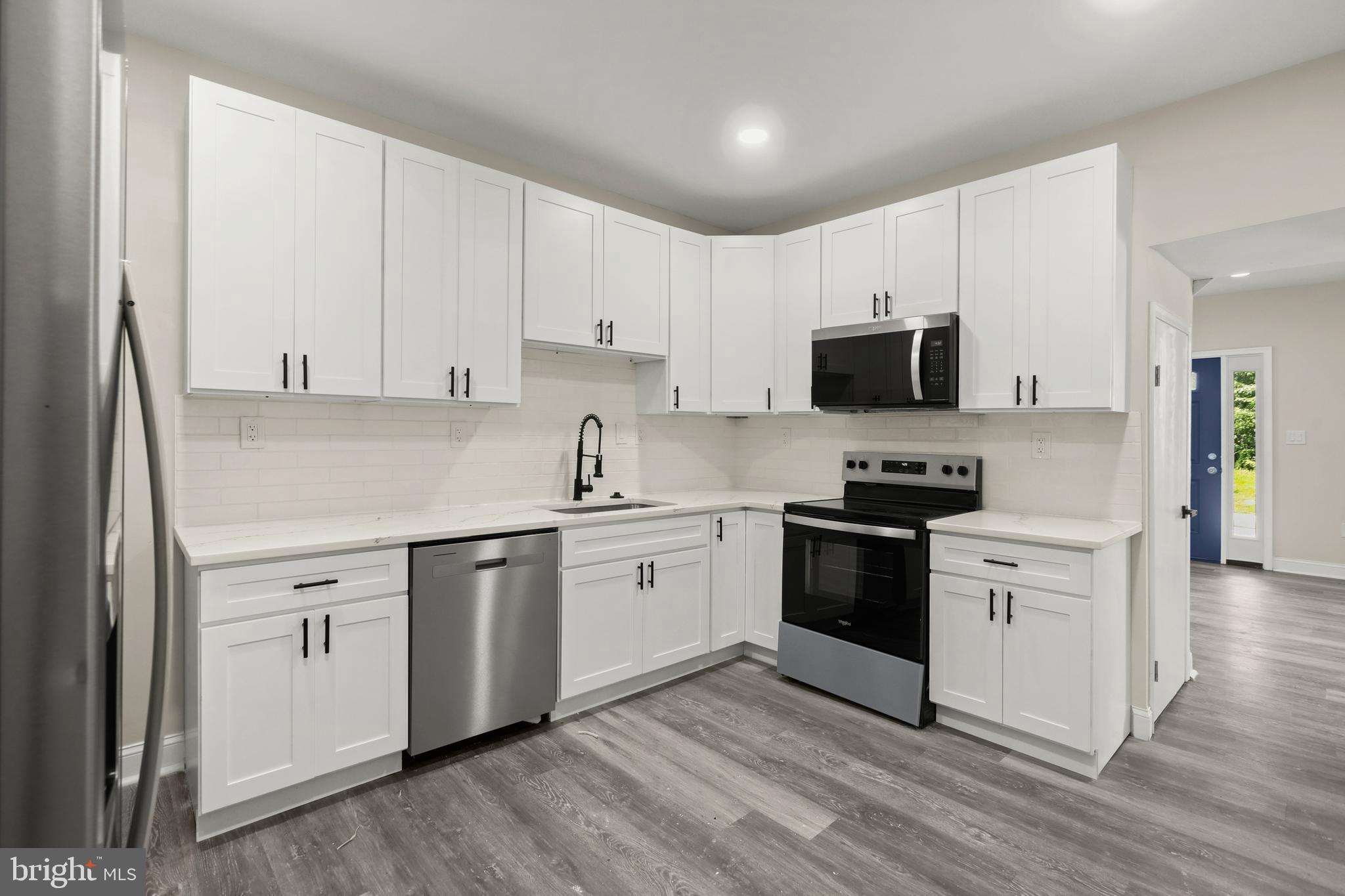 505 McCabe Avenue Baltimore, MD 21212 - Photo 18 of 46 a kitchen with granite countertop white cabinets and white appliances