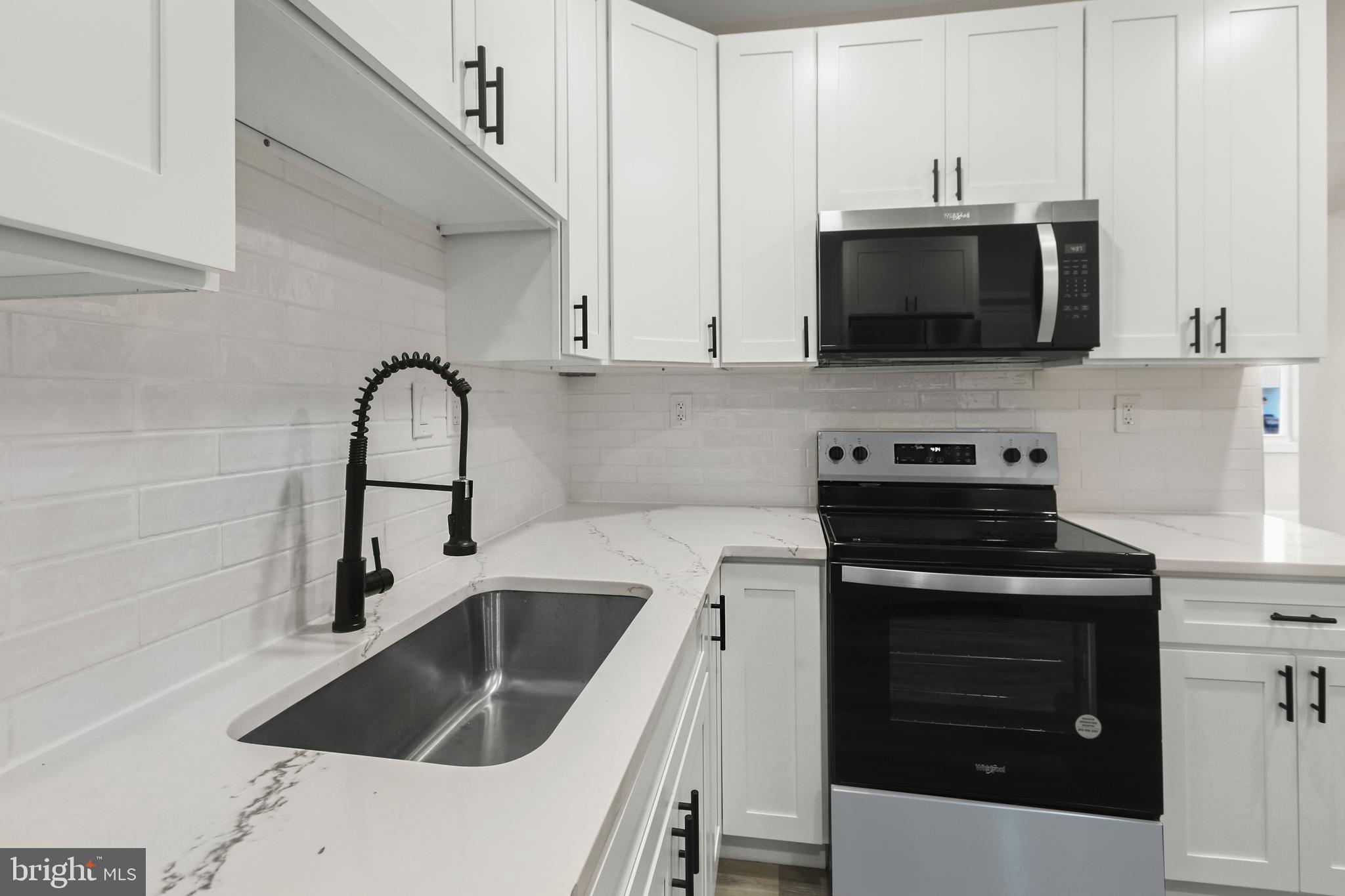 505 McCabe Avenue Baltimore, MD 21212 - Photo 20 of 46 a kitchen with stainless steel appliances a stove a sink and a microwave