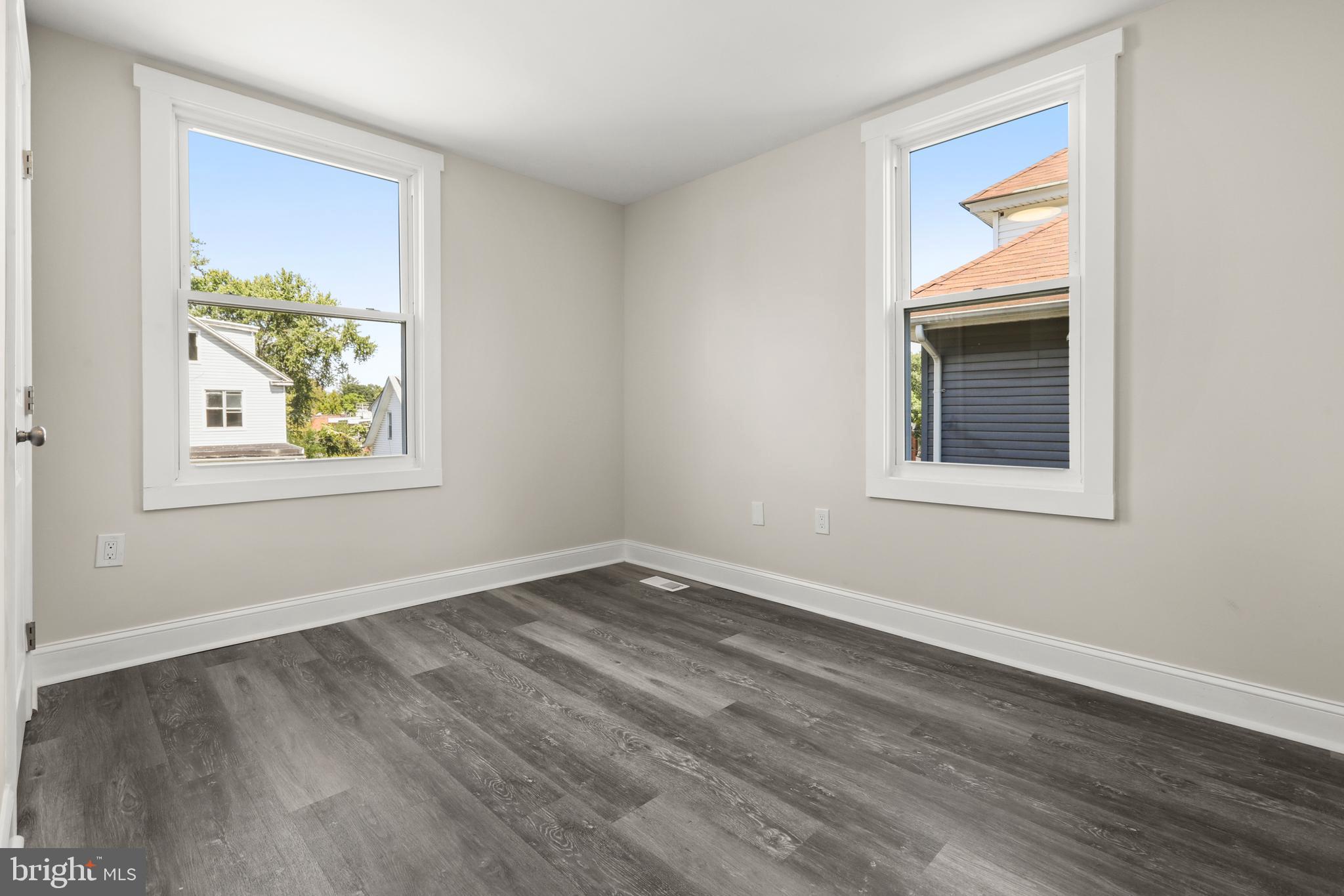 505 McCabe Avenue Baltimore, MD 21212 - Photo 26 of 46 a view of an empty room with window and wooden floor
