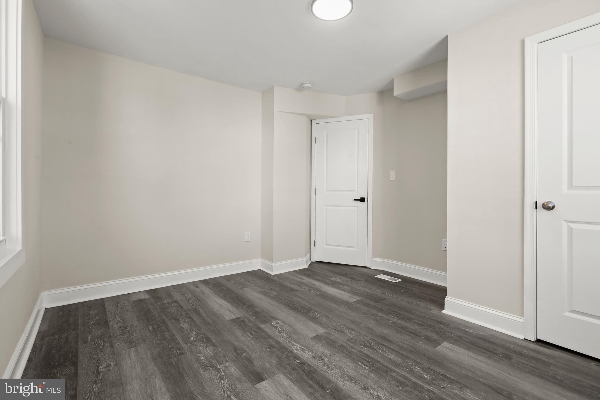 505 McCabe Avenue Baltimore, MD 21212 - Photo 27 of 46 a view of an empty room with wooden floor