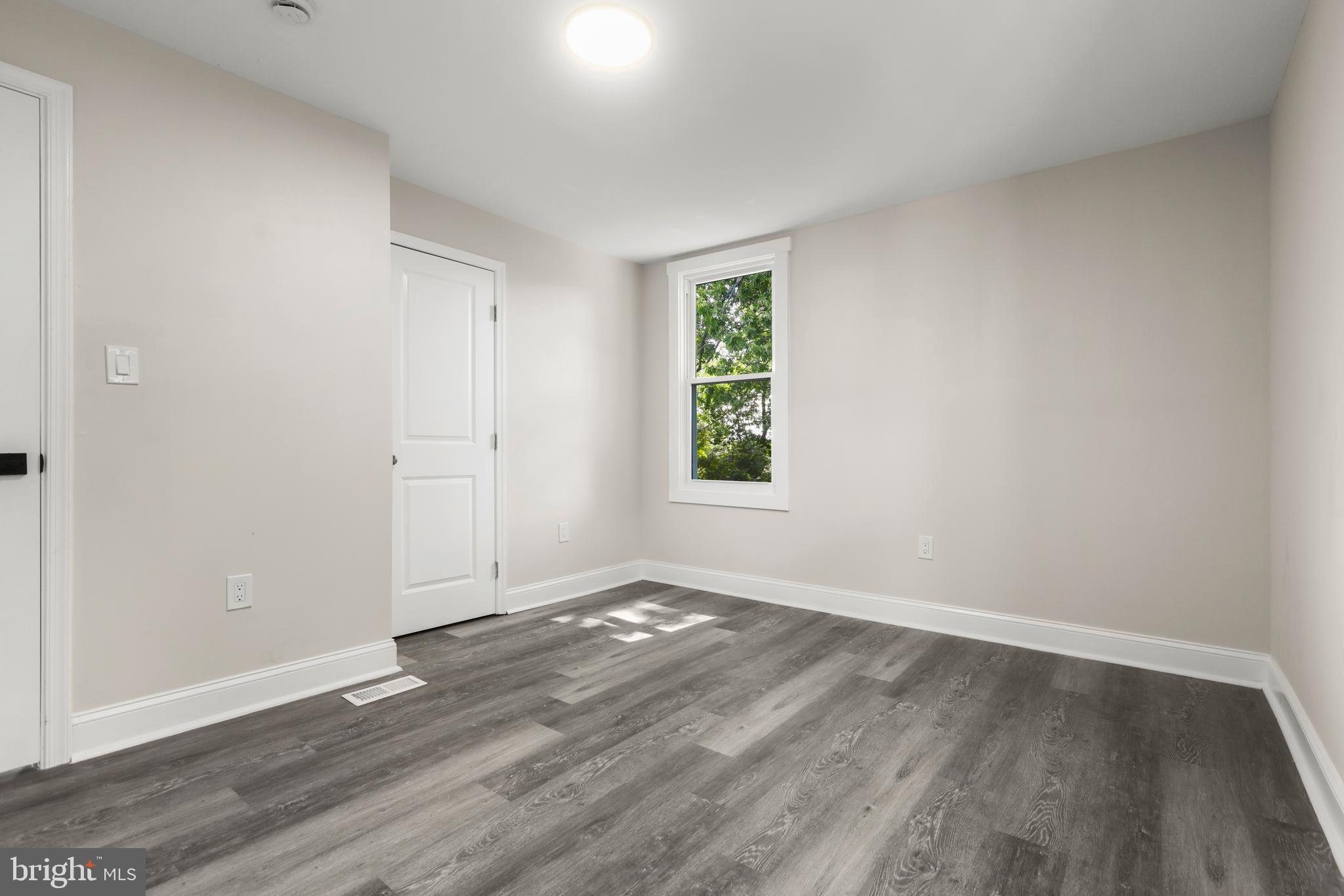 505 McCabe Avenue Baltimore, MD 21212 - Photo 30 of 46 an empty room with wooden floor and windows