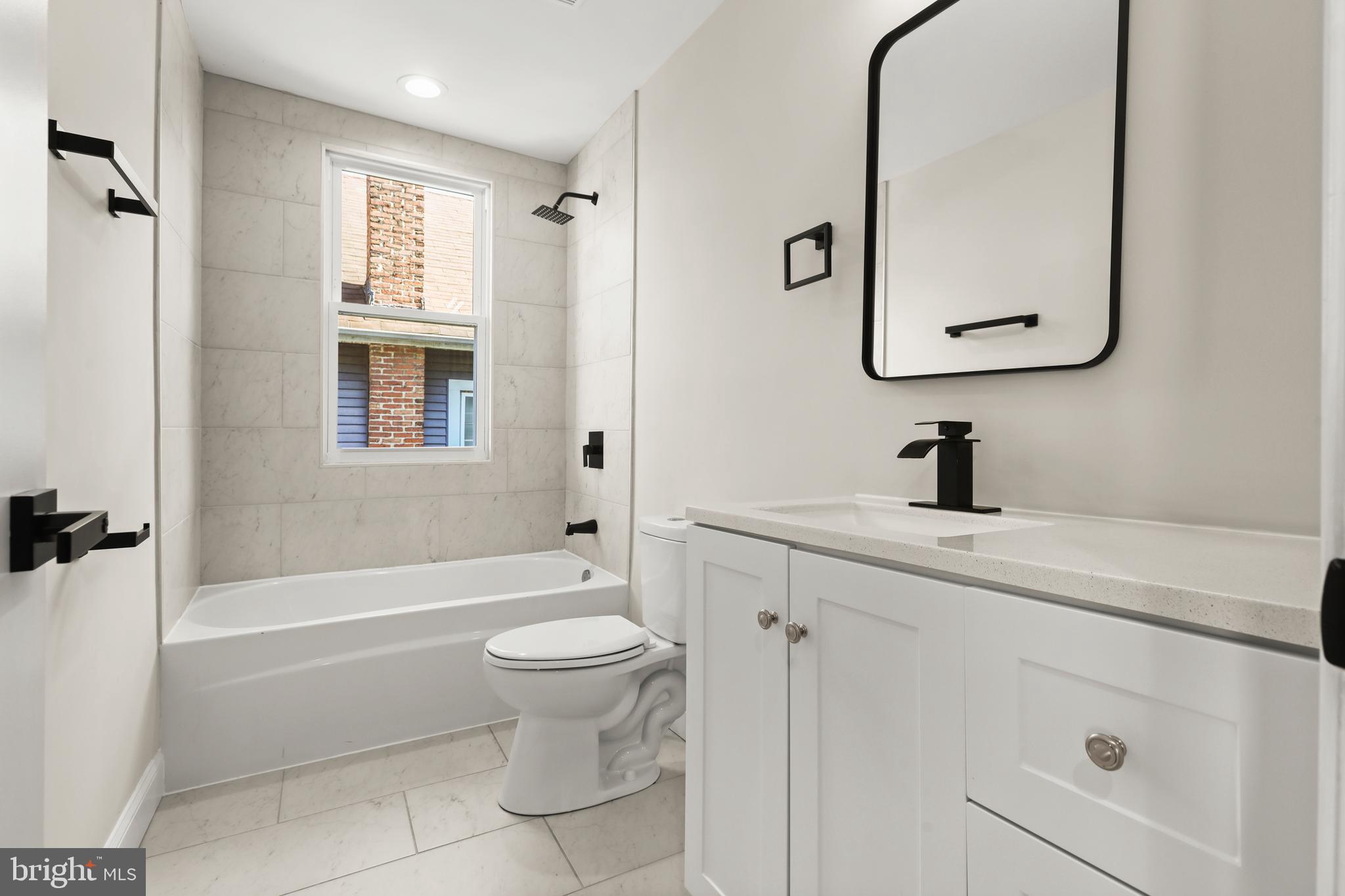 505 McCabe Avenue Baltimore, MD 21212 - Photo 32 of 46 a bathroom with a sink a toilet and shower