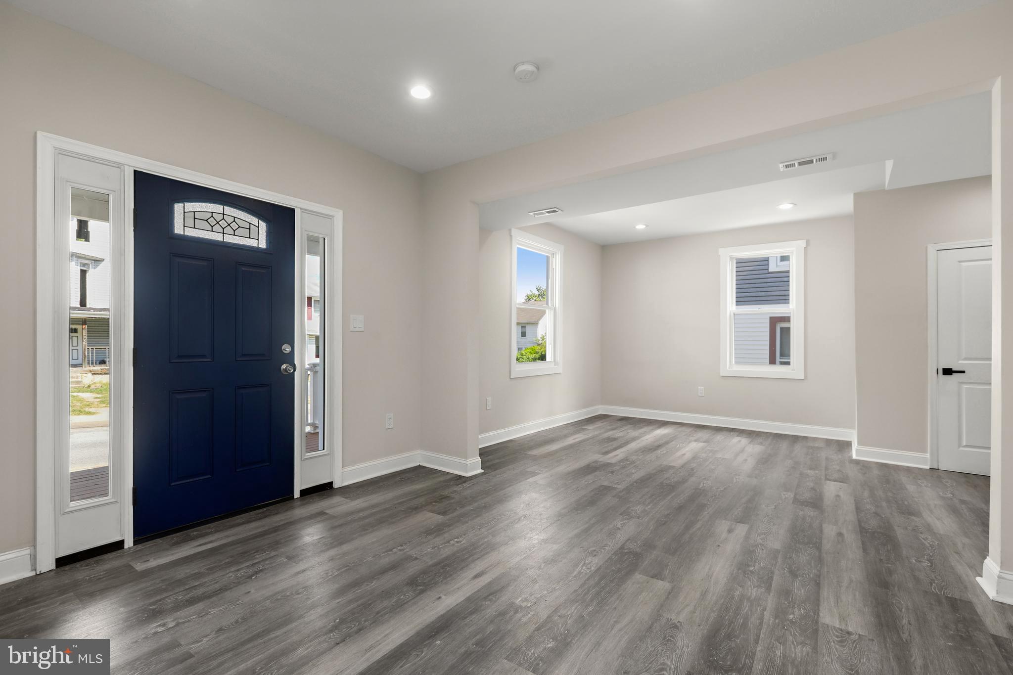 505 McCabe Avenue Baltimore, MD 21212 - Photo 8 of 46 an empty room with wooden floor and windows