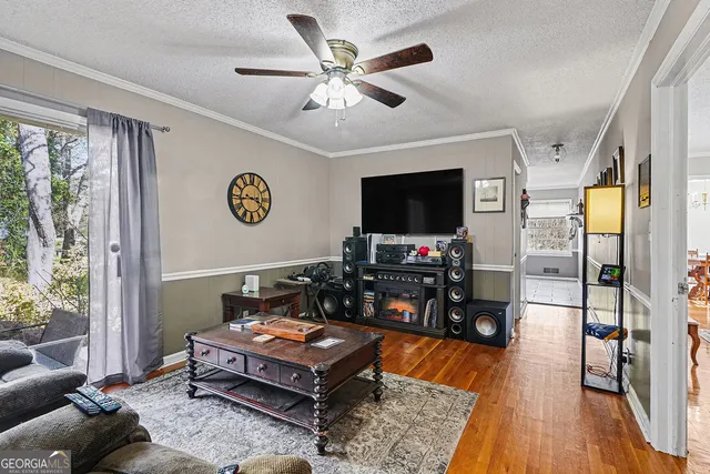 a living room with furniture and a flat screen tv