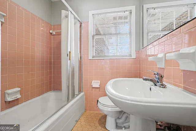 a white bath tub sitting next to a white sink