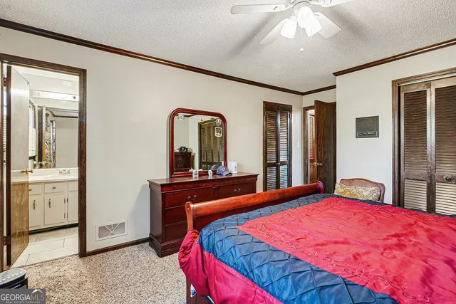 a bed room with a bed and a large mirror