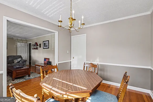 a room with a chandelier and a rug