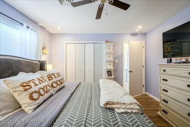 a bedroom with a bed and flat screen tv