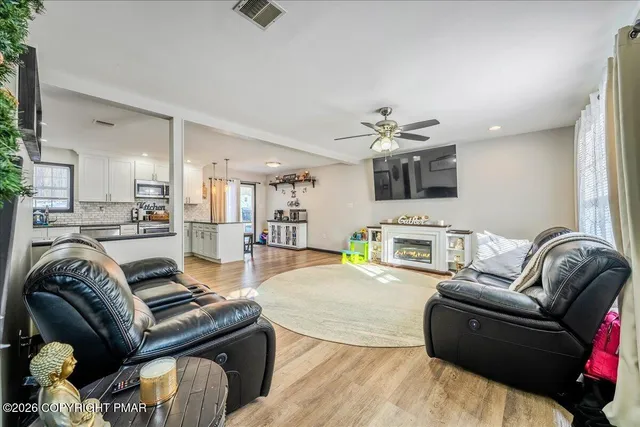 a living room with furniture and a fireplace
