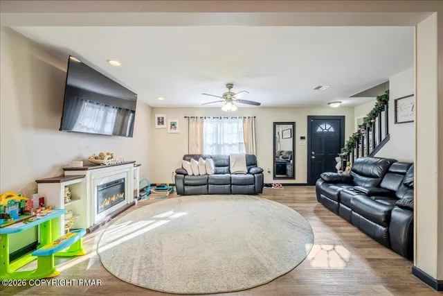 a living room with furniture and a wooden floor