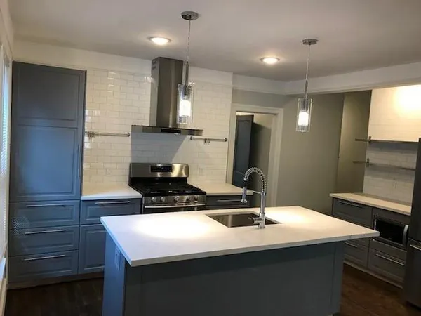 a kitchen with a sink and a refrigerator