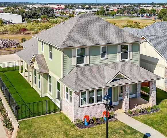 a aerial view of a house with swimming pool and porch