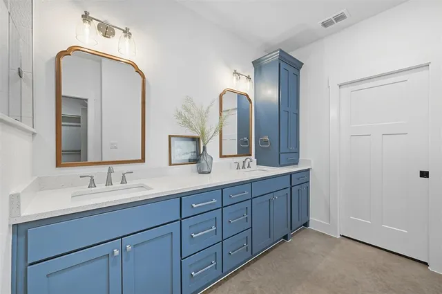 a bathroom with a double vanity sink and a mirror