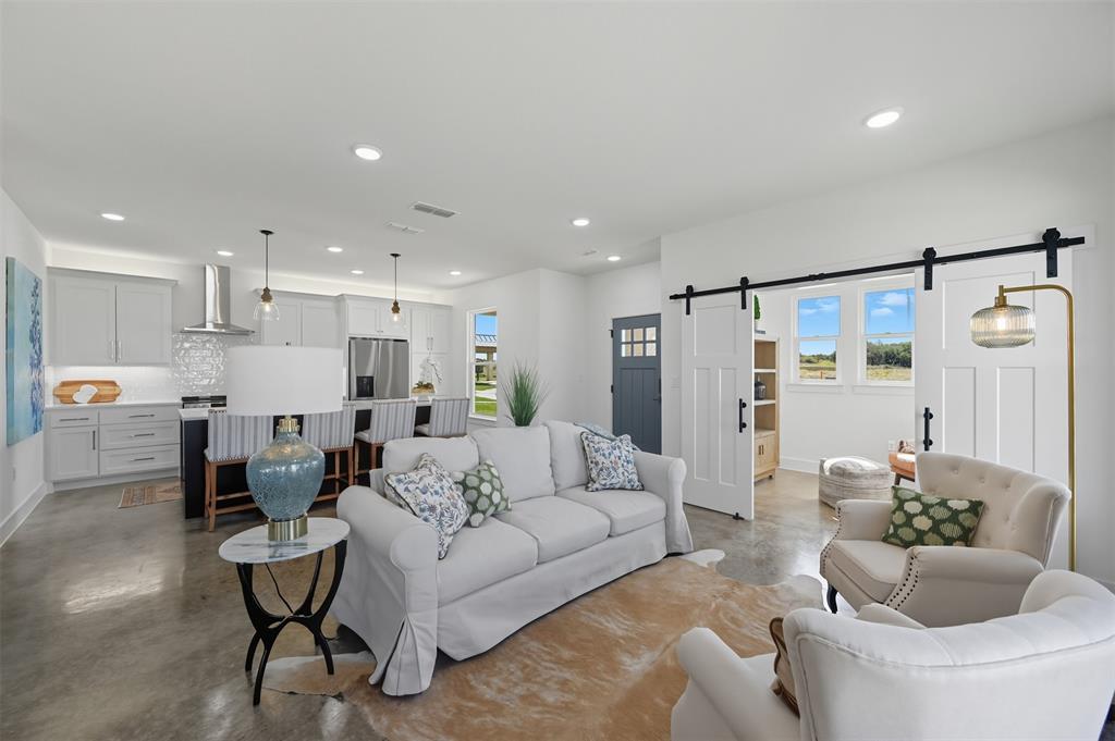 104 Cardinal Wds Granbury, TX 76049 - Photo 5 of 23 Living room with finished concrete flooring, a barn door, and recessed lighting