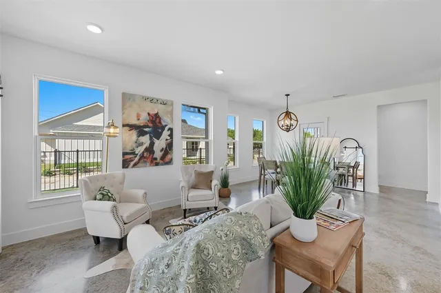 a living room with furniture potted plant and window