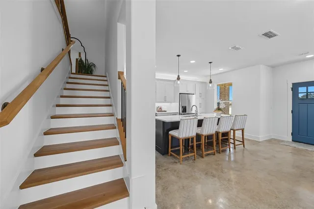 a view of a dining area with furniture and stairs