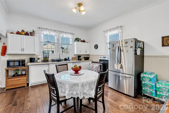 a kitchen with stainless steel appliances granite countertop a refrigerator and a stove top oven