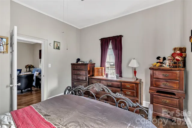 a bedroom with a bed and a dresser in it