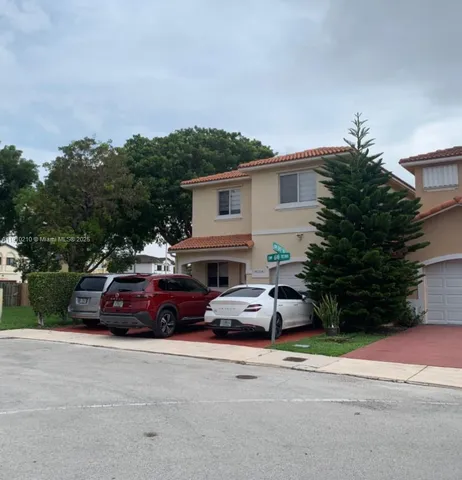 a view of a car parked in front of a house