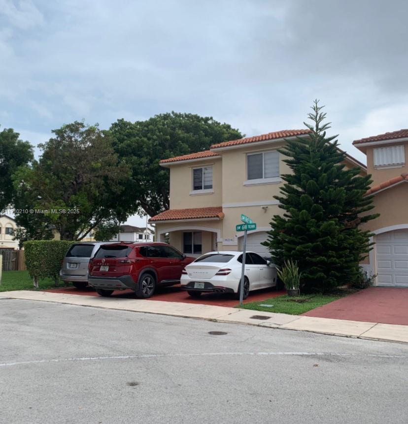 a view of a car parked in front of a house