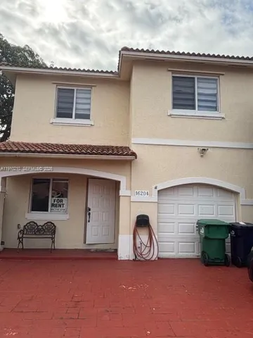 a view of a house with a patio and a fireplace