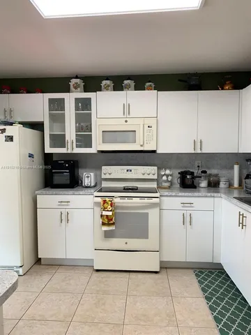 a kitchen with stainless steel appliances a stove a sink and a refrigerator
