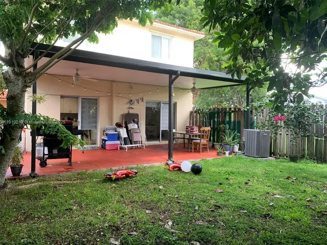 a view of a backyard with sitting area and slide