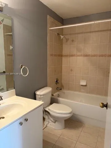a bathroom with a toilet a sink and shower