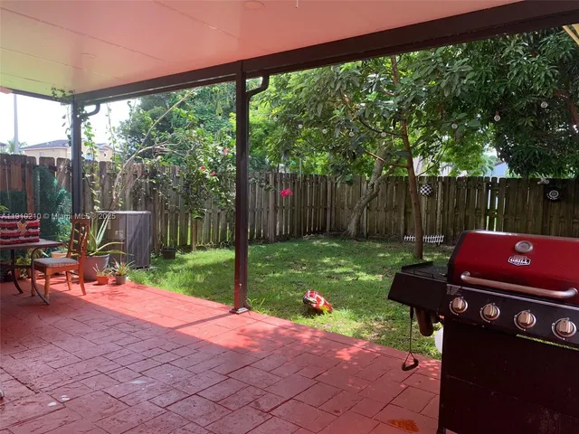 a view of a backyard with sitting area and furniture