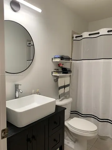a bathroom with a sink toilet and mirror