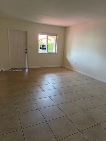 an empty room with a empty space and a window