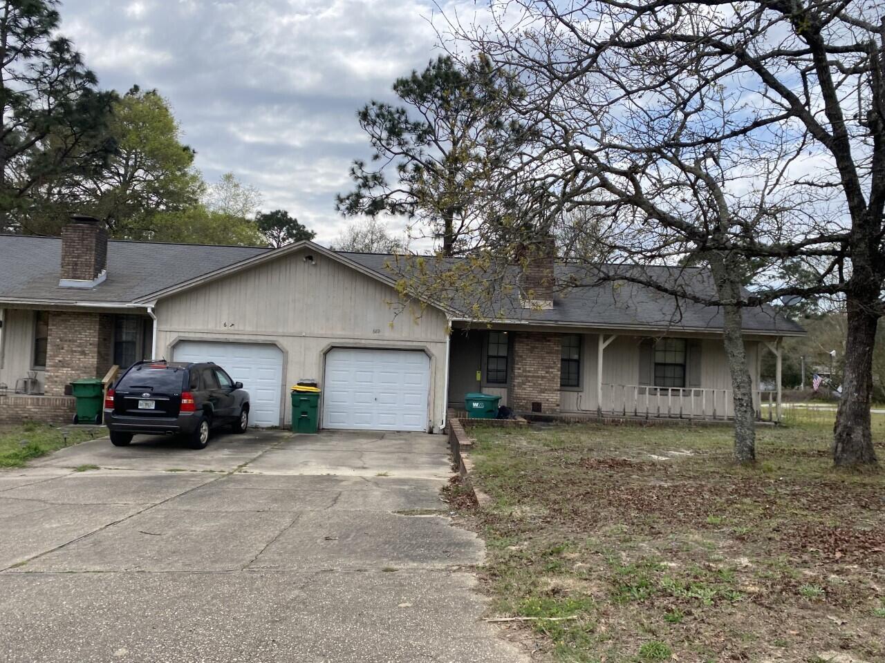 689 Valley Road, Unit 687689 Crestview, FL 32539 - Photo 2 of 3 a black car in front of white house