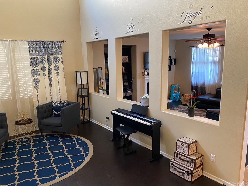 537 Kennedy Street Rialto, CA 92376 - Photo 8 of 32 Formal Living Room looking into Family room with custom bookcase/shelving.