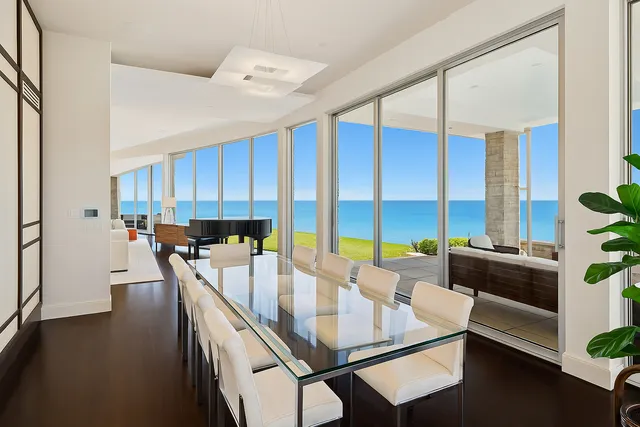 a living room with furniture and floor to ceiling windows