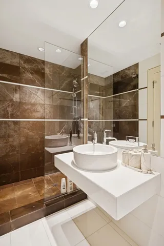 a kitchen with stainless steel appliances granite countertop a refrigerator and a stove